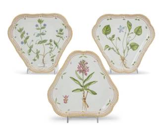 415 Three Royal Copenhagen porcelain 'Flora Danica' triangular cake plates Date codes for 1969-74 Each with green printed factory mark above underglaze blue wave and green painted pattern 20 over shape number 3508, black painted titles in Latin 3 pieces Each: 9" W x 8.25" D Estimate: $1,500 - $2,000