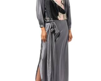 127 Michaele Vollbracht: A Grey Silk Beaded Portrait Evening Dress Circa 1980s Label: Michaele Vollbracht A long grey silk satin gown with blouson-style top featuring a fully beaded design of an embracing kissing couple, the top with wide dolman sleeves, gathered shoulders with shoulder pads, and the dropped waist bias skirt in a two-panel wrap style with extra-long bias satin sash belt  No size label: bust across front: 20 in.; waist: 18 1/2 in. hips: 19 in. (bias); sleeves: 23 in.; CB length: 60 in.; belt: 144 in. approximately Estimate: $400 - $600