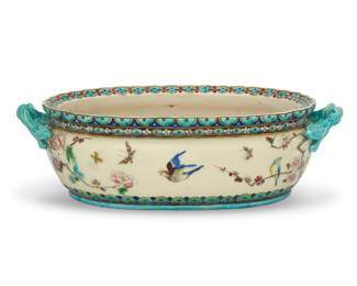 312 A Théodore Deck glazed earthenware jardinière Théodore Deck (1823-1891), late 19th century Impressed to underside: TH [conjoined] DECK With opposed figural handles, depicting birds and floral motifs 4.875" H x 16.625" W x 8.75" D Estimate: $2,000 - $3,000