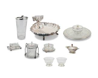 211 A group of sterling silver and silver plated table items Late 19th/20th century Undertray marked: International Sterling / Lord Saybrook / H278; sugar with British hallmarks for sterling, 1927, Sheffield, and maker: R&B Comprising an English sterling silver lidded sugar, a four-section glass server on a sterling tray, a silver-plated footed shell-form server with glass-lined sauce vessel, a cut glass ice bucket in silver-plated holder, two partitioned glass bowls with sterling feet, two glass dishes in silver-plated holders, and a silver-plate-mounted glass carafe, the undertray inscribed with honorific 9 pieces Shell server: 6.5" H x 12.375" W x 13" D; Sugar: 4.75" H x 7.5" W x 4.5" D Total weighable sterling: 31.5 gross oz. troy approximately Estimate: $150 - $200