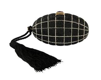 123 Judith Lieber: A Black & White Crystal 'Grenade' Minaudière Marked to interior plaque: Judith Leiber / © A black and white checked crystal-covered flat oval clutch bag with black cord tassel, gold-toned hardware and set amethyst clasp closure, a drop-in chain strap, gold leather lining and matching coin purse as well as a gold compact mirror and gold comb with tassel  4 1/2 in. H x 7 in W x 1 1/2 in. D; chain drop: 21 in. Estimate: $600 - $800