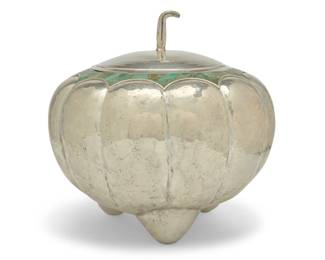 260 An Emilia Castillo silver plated gourd vessel Mid-20th century With etched signature: Emilia Castillo; impressed: Emilia Castillo / Mexico MR. / Plateado / T0-85 Plated hammered copper, with lobed body, tripod legs, and stem finial, the rim mounted with malachite accents 14.375" H x 14.75" Dia. Estimate: $600 - $800