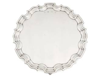 290 An English sterling silver footed salver 1992 With British hallmarks for sterling, Sheffield, date, and maker: RC [in hexagonal cartouche, Carr's] With scalloped rim, raised on three scrolled feet 1.25" H x 12" Dia. 28.4 oz. troy approximately Estimate: $700 - $900