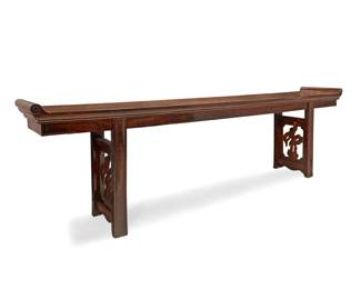 336 A large Chinese carved hardwood altar table 20th century With scrolled molding at each end, raised on pedestal supports carved with openwork cloud motifs 37.75" H x 126" W x 20" D Estimate: $3,000 - $5,000