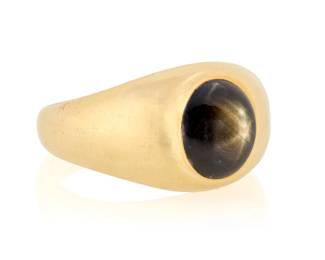 103 A 14K gold and Black Star Sapphire Ring Of a signet design centering an oval black star sapphire cabochon weighing approximately 6.70 carats  Size: 11 12.3 grams Estimate: $1,200 - $1,500