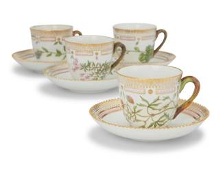 404 A set of twelve Royal Copenhagen porcelain 'Flora Danica' tea cups and saucers Date codes for 1955-1974 Each with green printed factory mark above underglaze blue wave and green painted pattern 20 over shape number 3597, black painted titles in Latin 12 pieces Each cup: 2.75" H; Each saucer: 5.375" Dia. Estimate: $2,500 - $3,500