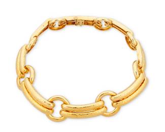 117 David Webb: An 18K Gold Collar Necklace Featuring bright gold textured links and large circular connectors, signed Webb  Measures: 14 3/4 in. 180.8 grams gross Estimate: $15,000 - $20,000