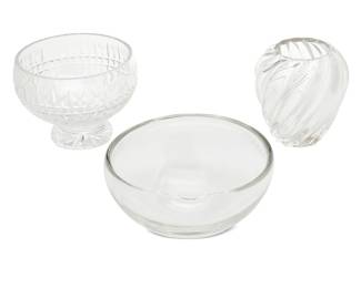 449 Three designer glass vessels Mid/late 20th century Each with factory marks Comprising a Waterford bowl (7.25" H x 9.875" Dia.), a Cartier vase (8" H x 7.75" Dia.), and an Elsa Peretti for Tiffany bowl (5.25" H x 11.25" Dia.) 3 pieces Estimate: $300 - $500