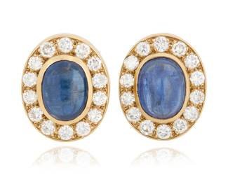84 A Pair of 10K Gold, Sapphire and Diamond Earclips Centering two oval sapphire cabochons weighing approximately 5.60 carats each, encircled by round diamonds weighing approximately 1.96 carats total 2 pieces  Measures: 3/4 x 1/2 in. 11.8 grams gross Estimate: $1,000 - $2,000