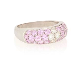 42 An 18K Gold, Pink Sapphire and Diamond Ring Featuring round pink sapphires weighing approximately 2.40 carats, centering four round diamonds  Size: 8 3/4 7.5 grams gross Estimate: $1,200 - $1,800