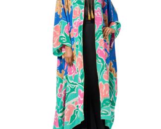164 Oscar de la Renta: A Printed Silk Kimono Robe Circa 1980s-1990s Label: Oscar de la Renta A printed silk caftan style oversize robe in bold colors of blue, green, pink, salmon, and cream, with metallic gold cord trim and tassel ties to front neck  No size label: CB length: 49 in.; sleeves: 27 in. (from neckline); back width at hem: 41 in. Estimate: $300 - $500