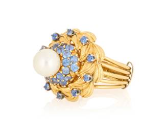 83 Rondette: An 18K Gold, Cultured Pearl and Sapphire Centering a round cultured pearl, set in a floral gold dome design accented by round sapphires, signed Rondette  Size: 6 with sizing band 13.8 grams Estimate: $2,000 - $3,000
