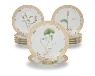 412 A set of twelve Royal Copenhagen porcelain 'Flora Danica' bread & butter plates Date codes for 1956-67 Each with green printed factory mark above underglaze blue wave and green painted pattern 20 over shape number 3552, black painted titles in Latin 12 pieces Each: 5.75" Dia. Estimate: $2,000 - $3,000