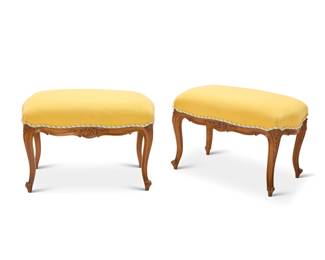 247 A pair of Louis XV style upholstered benches 20th century Each carved with floral accents and scroll feet, upholstered in a yellow fabric with braided trim 2 pieces Each: 19" H x 25.5" W x 15.75" D Estimate: $700 - $900