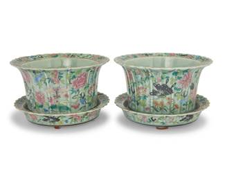 252 A pair of Chinese Famille Rose porcelain jardinières 20th century Each unmarked Each depicting birds, floral motifs, butterflies, and other insects on a pale green ground, with conforming drip underplate 2 pieces Each overall: 9" H x 14.25" Dia. Estimate: $400 - $600