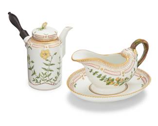 417 Two Royal Copenhagen porcelain 'Flora Danica' table items 1969-1978 Each with green printed factory mark above underglaze blue wave and green painted pattern 20 over shape numbers 3620 or 3556, black painted titles in Latin Comprising a sauce boat with attached underplate, and a lidded chocolate pot with ebonized turned wood handle 2 pieces Sauce boat: 5" H x 9.25" W x 6.875" D; Chocolate pot: 7" H x 8.875" W x 5.625" D Estimate: $3,000 - $5,000