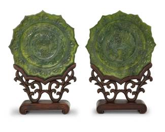 253 A pair of Chinese carved hardstone plates 20th century Each bearing an apocryphal reign mark for Qianlong Period (1736-1795) Comprising one depicting a dragon and another depicting a qilin, each mounted on a custom hardwood stand 2 pieces Each plate: 10.875" Dia.; Each stand: 7.75" H x 10" W x 3.125" D Estimate: $500 - $700