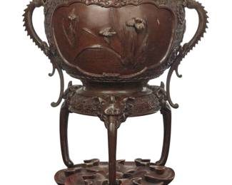 382 A Japanese patinated bronze censer Meiji/Taisho Period (1868-1926) Unknown impressed mark to underside With dragon-form handles and elephant-form tripod feet, raised on a carved hardwood stand Censer: 12.625" H x 11.5" W x 8.75" D; Base: 2.25" H x 7.25" Dia. Estimate: $300 - $500