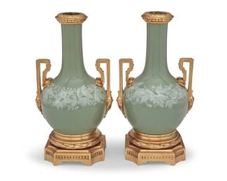 326 A pair of French pâte-sur-pâte celadon porcelain vases 20th century Each unmarked Each with Louis XV-style gilt-bronze foliate-form mounts and opposed handles 2 pieces Each: 14.875" H x 8.125" W x 7" D Estimate: $400 - $600