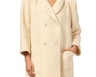 162 Valentino Garavani: A 'Miss V' Herringbone Cream Wool Coat Circa 1980s-1990s, Italy Labels: Valentino / Miss V / Made in Italy / 100% wool A heavy textured ivory cream wool double-breasted coat with front and back slightly gathered yokes, front patch pockets, and a V-neck shawl collar, with tonal viscose lining  Size 42 (Italy): CB length: 34.5 in.; sleeves: 22 in.; across back at shoulders: 17 1/2 in.; across front at underarms: 26 in. Estimate: $400 - $600