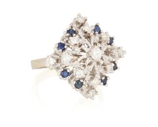 40 A 14K White Gold, Sapphire and Diamond Ring In a tiered design set with round sapphires, finished with round diamonds weighing approximately 0.65 carat  Size: 7 1/2 with sizing spring 9.6 grams gross Estimate: $300 - $500