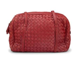 170 Bottega Veneta: A Vintage Red Intrecciato Woven Leather Shoulder Bag Marked to interior plaque: Bottega Veneta / Made in Italy A bowling style zip-top soft bag with woven leather exterior, two long handle straps and black leather lining to interior, with one zip pocket  7 in. H x 9 1/4 in. W x 4 in. D; drop: 14 in. Estimate: $300 - $500
