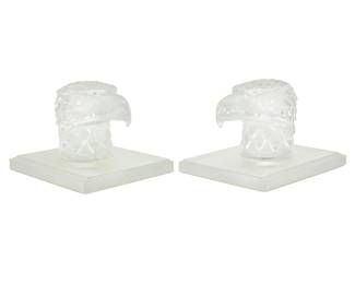 391 A pair of Lalique glass 'Tete D'Aigle' bookends Late 20th/early 21st century Each etched to base: Lalique ® / France 2 pieces Each: 5" H x 7.375" W x 5.875" D Estimate: $300 - $500