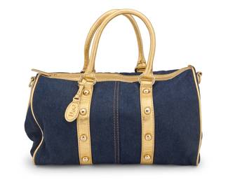 167 Dolce & Gabbana: A Blue Denim & Gold Leather Tote Bag Circa 2007 A medium bowling-style soft zip-top tote in washed dark denim with gold metallic leather straps and trim with gold-toned studs, hardware, and branded hangtag, lined with beige cotton twill, with one interior zip pocket, and detachable adjustable webbing shoulder strap  9 in. H x 14 in. W x 7 in. D; drop: 7 in. & 19+ in. Estimate: $200 - $300