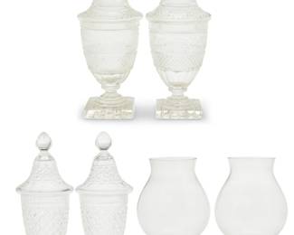 432 A group of Continental glass jars and hurricane lamps Late 19th-20th century Each unmarked Comprising two pairs of cut glass footed lidded jars, one pair decorated with frosted sylvan tableau to lids, and a pair of footed hurricane lamps 6 pieces Taller pair of jars: 14.25" H x 5.5" Dia.; Each hurricane: 10.125" H x 6.375" Dia. Estimate: $500 - $700