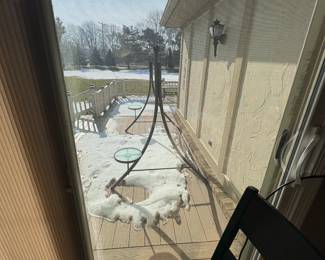 . . . frame for a patio swing with patio table and six chairs in the distance