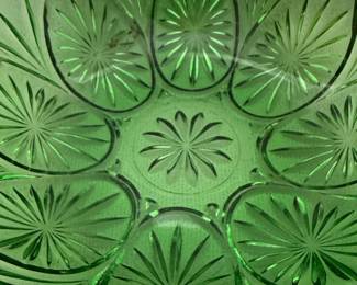 This set includes a green Jeannette Glass "Sunflower" cake plate and Anchor Hocking bowl. The cake plate features a prominent sunflower design with swirling leaves and a three-toed base.