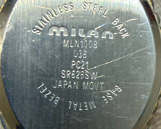 This lot contains two women's quartz wristwatches. The first is a Lorus watch with a silver-tone dial, silver-tone metal band, and a stainless steel caseback. It features a simple dial with hour markers and Arabic numerals at 12 and 6 o'clock. The second is a Milan watch with a champagne-colored dial, gold-tone bezel, and a two-tone metal band. It is marked as 'DIAMOND QUARTZ' and has a stainless steel back with a base metal bezel. Both watches appear to be functional quartz movements, suitable for everyday wear.