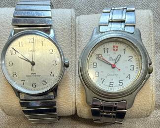This lot features two distinct wristwatches. The first is a Timex watch with a silver-tone dial, Arabic numerals, and 'WATER RESISTANT' marking. It has a metal expansion band and a base metal bezel with a stainless steel back, assembled in the Philippines. The second is a Bijou Terner quartz watch with a white dial, featuring a Swiss cross emblem at the 12 o'clock position, Arabic numerals, and 24-hour markings. It is marked 'JAPAN MOVT' and 'STAINLESS STEEL BACK'. Both watches show signs of wear consistent with age and use.