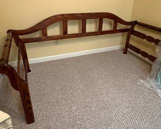 This vintage wooden twin size daybed set features a dark hardwood construction, likely walnut or mahogany, with a deep stain and semi-gloss finish. The headboard has a gracefully curved top rail with vertical slats and turned posts, while the footboard mirrors this design with turned posts and horizontal slats. The style suggests a traditional or Victorian influence, possibly a reproduction. The construction appears solid with visible joinery. No maker's marks are visible. The set includes a mattress in plastic wrapping.