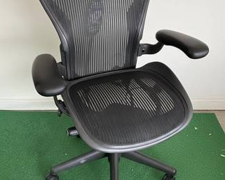 The Herman Miller Aeron Chair is an iconic ergonomic office chair designed by Don Chadwick and Bill Stumpf. Introduced in 1994, it revolutionized office seating with its innovative Pellicle mesh material, which conforms to the user's body and provides breathable support. The chair features a distinctive Y-shaped silhouette and a sophisticated tilt mechanism that allows for natural movement. Its adjustable armrests, lumbar support, and pneumatic height adjustment contribute to its exceptional comfort and adaptability for a wide range of users and tasks. The Aeron chair is known for its durability, ergonomic design, and timeless aesthetic, making it a staple in modern offices and homes.