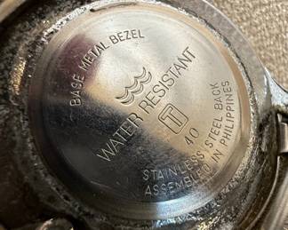 This lot features two distinct wristwatches. The first is a Timex watch with a silver-tone dial, Arabic numerals, and 'WATER RESISTANT' marking. It has a metal expansion band and a base metal bezel with a stainless steel back, assembled in the Philippines. The second is a Bijou Terner quartz watch with a white dial, featuring a Swiss cross emblem at the 12 o'clock position, Arabic numerals, and 24-hour markings. It is marked 'JAPAN MOVT' and 'STAINLESS STEEL BACK'. Both watches show signs of wear consistent with age and use.