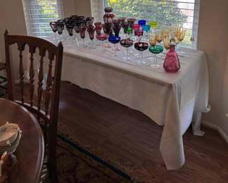 left: Bohemian dark ruby cut to clear wine glass set and ruby cut to clear cordial set, back row large Bohemian red cut to clear Vase