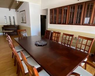 Solid double-pedestal parquet-top dining table, 70" L closed / 102" extended, with self-storing leaves and 10 coordinating chairs.