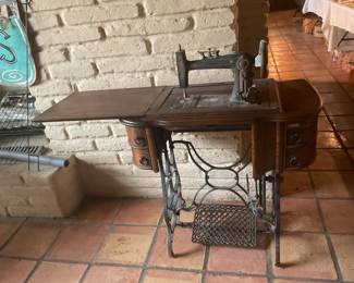 Antique sewing machine with beautiful cabinet