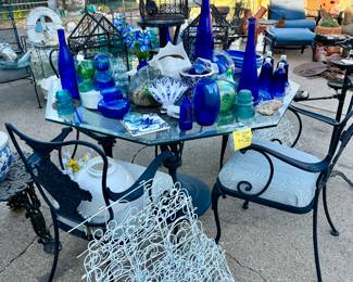SO MUCH ON THE PATIO INCLUDING THIS VINTAGE CAST IRON SEATING AND TABLE BASE.  LOTS OF BLUE AND WHITE, COBALT BLUE GLASS.
