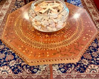 ANTIQUE FISHBOWL FULL OF SHELLS ON AN AMAZING ANTIQUE EARLY 19TH CENTURY MARQUETRY TABLE.