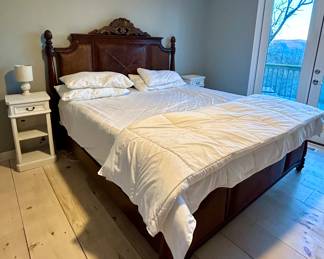 Tommy Bahama King bed with ornately carved wood headboard and coordinating footboard