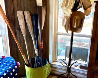 Lots of boat/canoe oars and cowboy hats