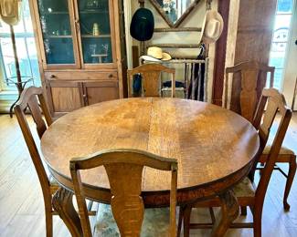 Tiger oak table with hand carved legs and clawed feet, on casters.  Chairs sold separately.