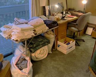 Most of the items here are bedding, but there is also a mirror, a desk chair, and a desk.