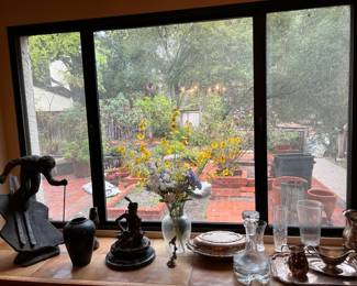 A nice view of the outside shows a pair of statues: a downhill skier and a seated figure are on the left.  More dishes and glassware are on the right.