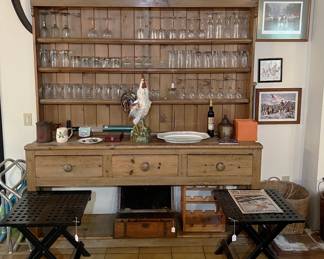 Here we have a pair of folding benches in front of a country-style shelf unit holding, in this case, glasses and stemware.