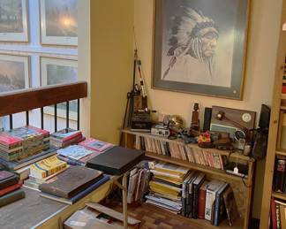 Near the painting is a small collection of books and media for you to peruse.