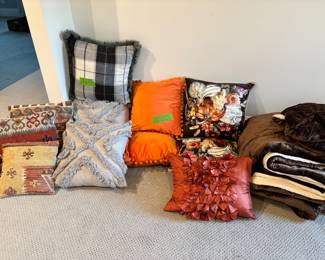 Assorted throw pillows is various colors, textures,sizes