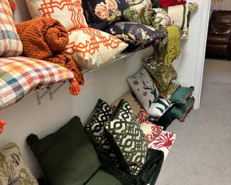 An entire giant closet filled with beautiful pillows, all in great shape